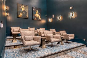 A row of chairs are lined up in a room with blue carpet.